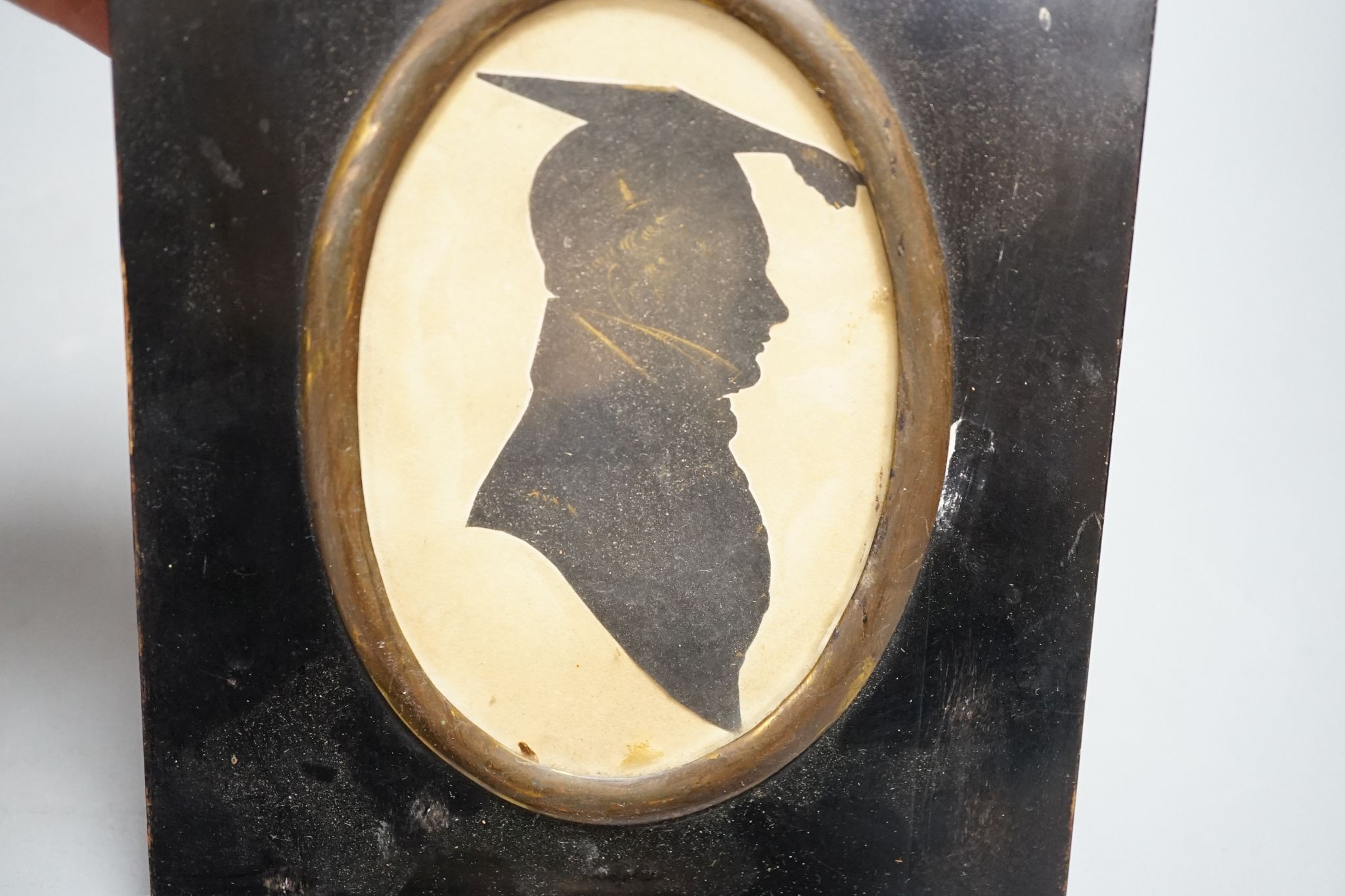 A plaster head relief and three silhouettes